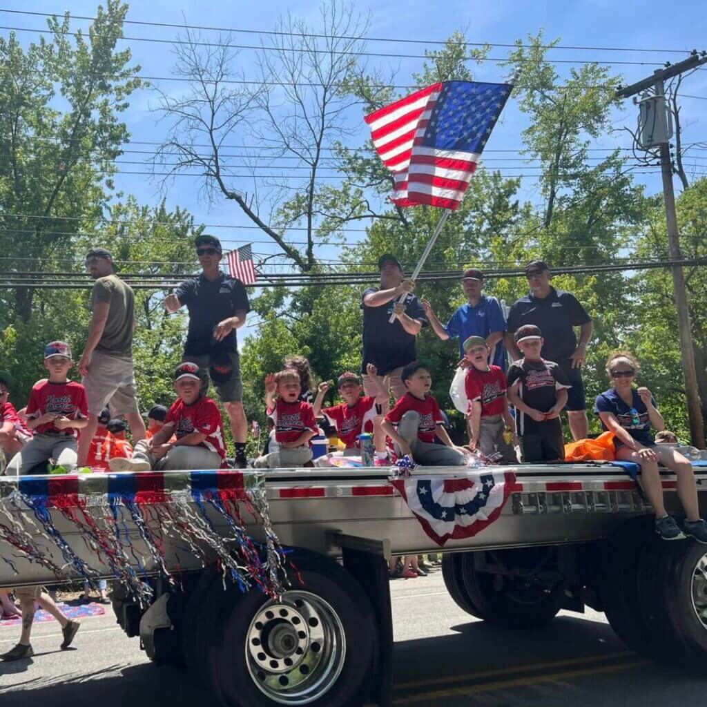 Parade float with children and an American flag